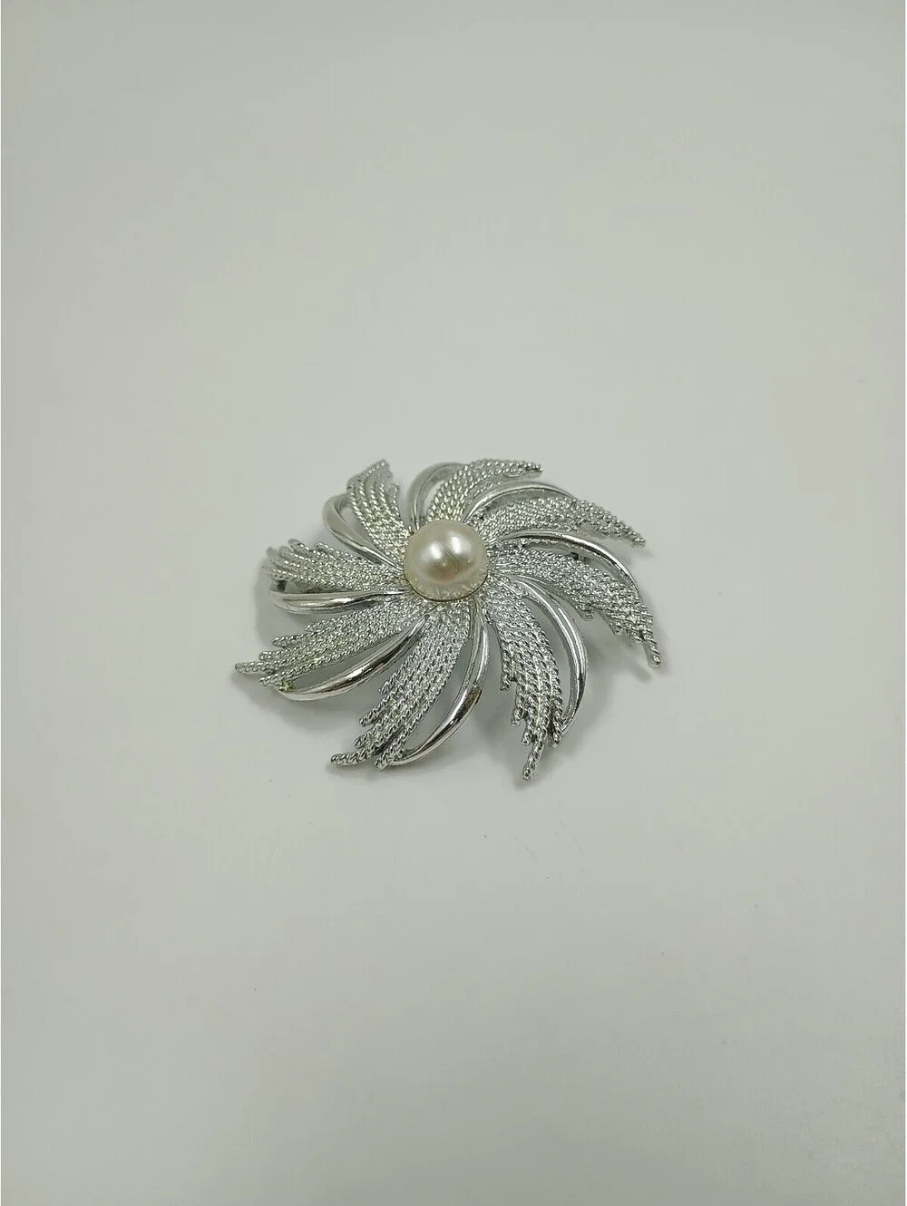 Elegant Silver-Tone Brooch with Pearl Center